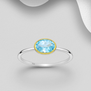 Bague en argent 925ème ornée d'un topaze bleu ciel sertie or 18 k